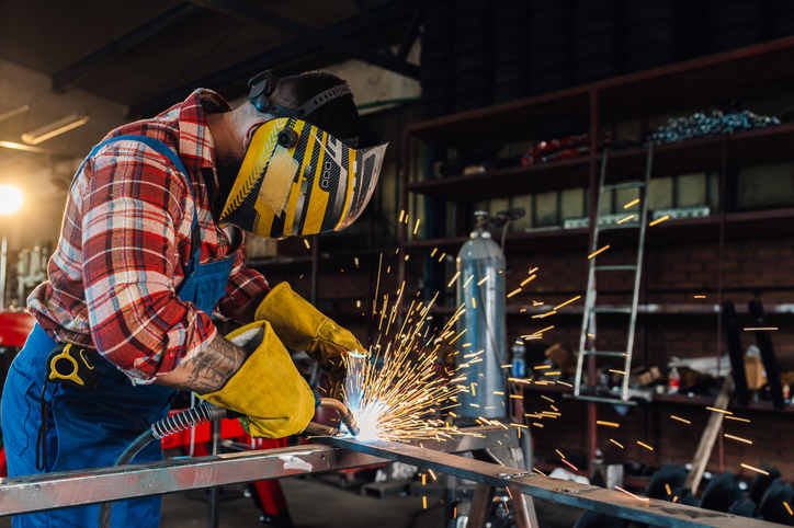 Welder with safety gear at work.