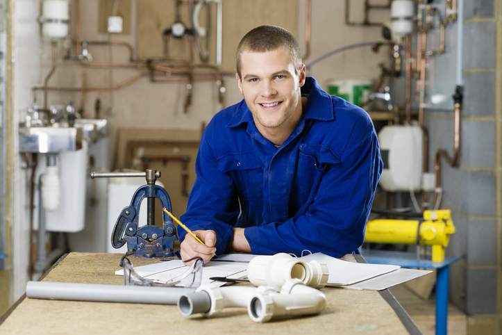 Apprentice plumber diagramming a solution.