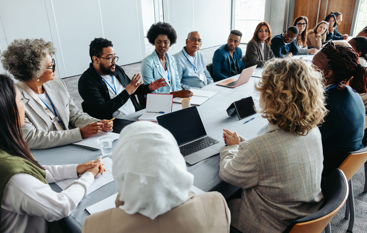 Business managers discussing an issue at work in a meeting.