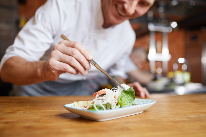 Chef plating a dish.