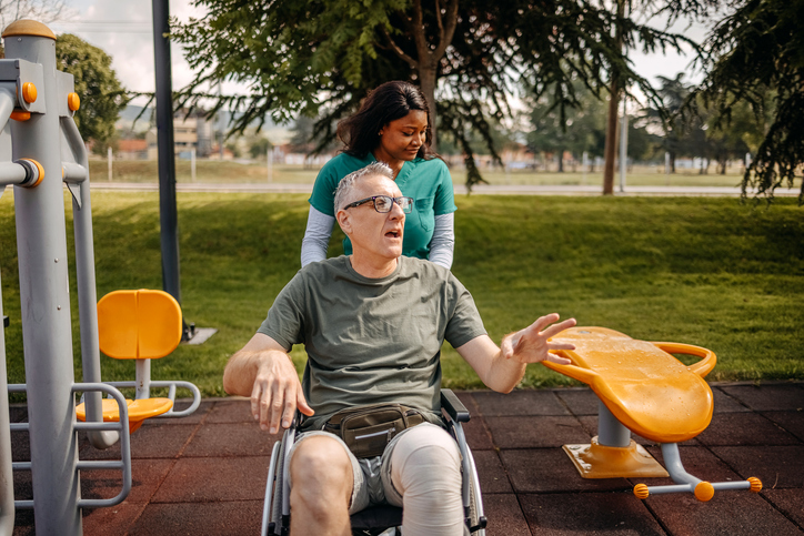 Physical therapy worker helping patient